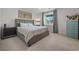 Serene bedroom with a plush bed, side tables, and a bright window at 329 Brockbank Pl, Henderson, NV 89011
