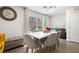 Elegant dining area with modern table and chairs, sliding glass door to outdoor area and statement wall at 329 Brockbank Pl, Henderson, NV 89011