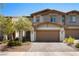 Inviting two-story townhome with a charming facade, two car garage and well-manicured landscaping at 329 Brockbank Pl, Henderson, NV 89011