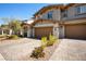 Stylish townhome featuring a two-car garage, landscaped front yard, and well-maintained exterior at 329 Brockbank Pl, Henderson, NV 89011