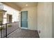 Covered front porch with a teal entry door and stone walkway at 329 Brockbank Pl, Henderson, NV 89011