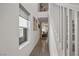 Bright hallway with wood-look tile flooring leading to the staircase at 329 Brockbank Pl, Henderson, NV 89011