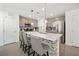 Spacious kitchen with an island, stainless steel appliances, and gray tile backsplash at 329 Brockbank Pl, Henderson, NV 89011