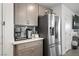 Kitchen with stainless steel refrigerator and grey cabinets at 329 Brockbank Pl, Henderson, NV 89011