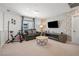 Cozy living room with a brick wall, a comfortable couch, and an entertainment center at 329 Brockbank Pl, Henderson, NV 89011