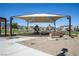 Community playground featuring covered play equipment, shade, and seating at 329 Brockbank Pl, Henderson, NV 89011