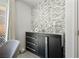 Cozy room featuring a decorative accent wall and a dark console table with decor at 329 Brockbank Pl, Henderson, NV 89011