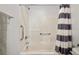 Walk-in shower with grab bars and a striped shower curtain at 329 Brockbank Pl, Henderson, NV 89011