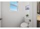 Small toilet room with window and toilet with white walls at 329 Brockbank Pl, Henderson, NV 89011