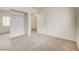 Bedroom with carpeted floor, closet with sliding mirrored doors, and entry to another room at 3318 N Decatur Blvd # 1061, Las Vegas, NV 89130