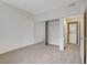 Bedroom with sliding mirrored closet doors and adjoining laundry closet with stacked washer/dryer at 3318 N Decatur Blvd # 1061, Las Vegas, NV 89130