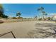 Dog park for residents featuring gravel, fencing, and mature palm trees at 3318 N Decatur Blvd # 1061, Las Vegas, NV 89130