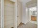 Hallway closet with white shelving leading to a bathroom at 3318 N Decatur Blvd # 1061, Las Vegas, NV 89130