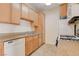 Bright kitchen featuring tile floors, wood cabinets, granite counters, and modern appliances at 3318 N Decatur Blvd # 1061, Las Vegas, NV 89130