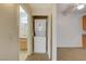 Hallway view into bathroom and laundry closet with stacked washer and dryer at 3318 N Decatur Blvd # 1061, Las Vegas, NV 89130