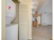 Laundry closet featuring a stacked washer and dryer unit in hallway near kitchen at 3318 N Decatur Blvd # 1061, Las Vegas, NV 89130