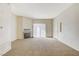 A spacious living room featuring neutral tones, a fireplace, and a sliding glass door at 3318 N Decatur Blvd # 1061, Las Vegas, NV 89130