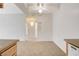 View of the open-plan living room with neutral carpet, ceiling fan, and access to other rooms at 3318 N Decatur Blvd # 1061, Las Vegas, NV 89130