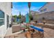Backyard featuring desert landscaping, lounge furniture, and a blue umbrella at 3389 Commendation Dr, Las Vegas, NV 89117