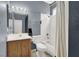 Well lit bathroom with vanity, commode, and shower/tub combo with white tile surround at 3389 Commendation Dr, Las Vegas, NV 89117