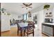 Bright dining area with wood floors, a ceiling fan, and sliding door to a lovely backyard at 3389 Commendation Dr, Las Vegas, NV 89117