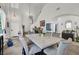 Elegant dining area featuring a marble table, plush chairs, and soaring ceilings with modern lighting fixtures at 3389 Commendation Dr, Las Vegas, NV 89117