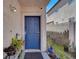 Charming blue front door surrounded by lush greenery, complementing the home's inviting entrance at 3389 Commendation Dr, Las Vegas, NV 89117