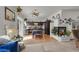Open-concept living area with a fireplace, kitchen view, and a cozy ambiance for relaxing and entertaining at 3389 Commendation Dr, Las Vegas, NV 89117