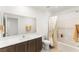 Bright bathroom featuring a shower-tub combo and a single sink vanity with wood cabinetry at 3518 Herodain Ave, Las Vegas, NV 89106