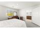 Well lit bedroom featuring a bed and dresser, and an entrance to the bathroom at 3518 Herodain Ave, Las Vegas, NV 89106