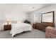 Bright bedroom features a comfy bed, a wooden dresser, and a window for natural light at 3518 Herodain Ave, Las Vegas, NV 89106
