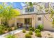 Attractive townhome with a cozy front porch, enhanced by potted plants and landscaping at 3518 Herodain Ave, Las Vegas, NV 89106