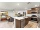 Open-concept kitchen and living area with island seating and stainless appliances at 3518 Herodain Ave, Las Vegas, NV 89106