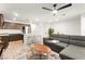 Open-concept living space with kitchen, a modern ceiling fan and comfortable seating at 3518 Herodain Ave, Las Vegas, NV 89106