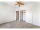 Neutral carpeted bedroom featuring bright walls, ceiling fan, and sliding door closet at 3786 Port Ritchey St, Las Vegas, NV 89147
