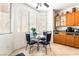 Inviting dining area with a glass table, natural light, and adjacent cabinets for convenient storage and serving at 3786 Port Ritchey St, Las Vegas, NV 89147