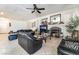 Spacious living room featuring a cozy fireplace, tile floors, and abundant natural light from the window at 3786 Port Ritchey St, Las Vegas, NV 89147