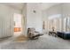 Bright living room with high ceilings, large windows, and comfortable seating area at 3786 Port Ritchey St, Las Vegas, NV 89147
