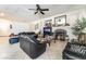 Spacious living room featuring a cozy fireplace, tile floors, and abundant natural light from the window at 3786 Port Ritchey St, Las Vegas, NV 89147