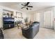Spacious living room featuring a cozy fireplace, tile floors, and abundant natural light from the window at 3786 Port Ritchey St, Las Vegas, NV 89147