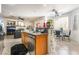 Modern open concept kitchen and living room featuring stainless appliances, granite countertops and a cozy fireplace at 3786 Port Ritchey St, Las Vegas, NV 89147