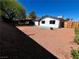 Expansive backyard with concrete patio area, accented by decorative gravel and mature trees at 407 Tiger Lily Way, Henderson, NV 89015