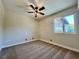 Well-lit bedroom with a ceiling fan and a large window at 407 Tiger Lily Way, Henderson, NV 89015