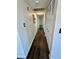 Hallway with laminate flooring and white closet doors provide storage space and functionality at 407 Tiger Lily Way, Henderson, NV 89015