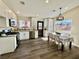 Bright kitchen with white cabinets, stainless steel appliances, and dining area at 407 Tiger Lily Way, Henderson, NV 89015