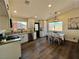 Spacious kitchen and dining area boasting stainless steel appliances, granite counters, and stylish wood flooring at 407 Tiger Lily Way, Henderson, NV 89015