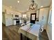 Bright kitchen featuring white cabinets, stainless steel appliances, and a dining area with stylish lighting at 407 Tiger Lily Way, Henderson, NV 89015