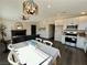 Open concept living room and kitchen with a fireplace and modern lighting at 407 Tiger Lily Way, Henderson, NV 89015