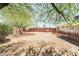 The backyard features desert landscaping and a red brick wall at 429 Scenic Dr, Henderson, NV 89002