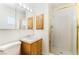 Cozy bathroom featuring a vanity with a single sink, a mirror with lighting, and a glass-enclosed shower stall at 429 Scenic Dr, Henderson, NV 89002